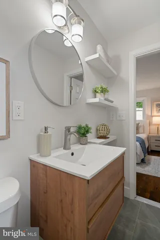 a bathroom with a sink a toilet and a mirror