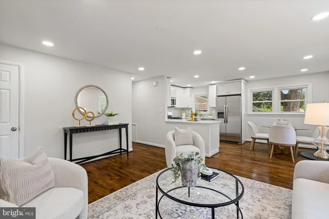 a living room with furniture kitchen view and a dining table