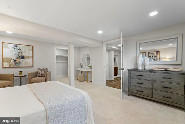 a bedroom with a bed and a large mirror