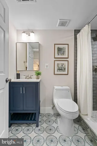 a bathroom with a toilet a sink and mirror