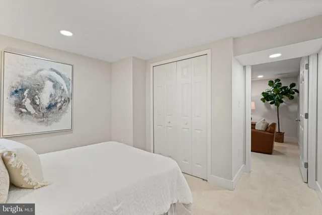 a bedroom with a bed and a painting on the wall