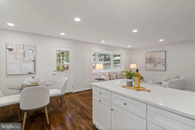 a kitchen with a sink dining table and chairs
