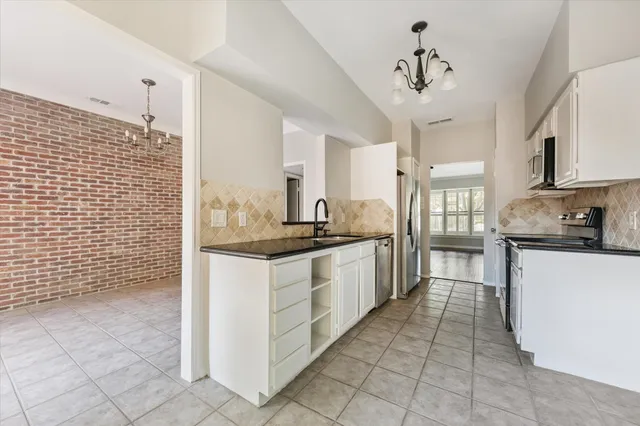 a kitchen with stainless steel appliances granite countertop a sink and cabinets