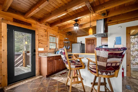 a view of a bedroom with furniture and a window