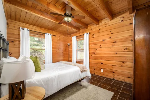 a bathroom with a granite countertop sink a mirror and a shower