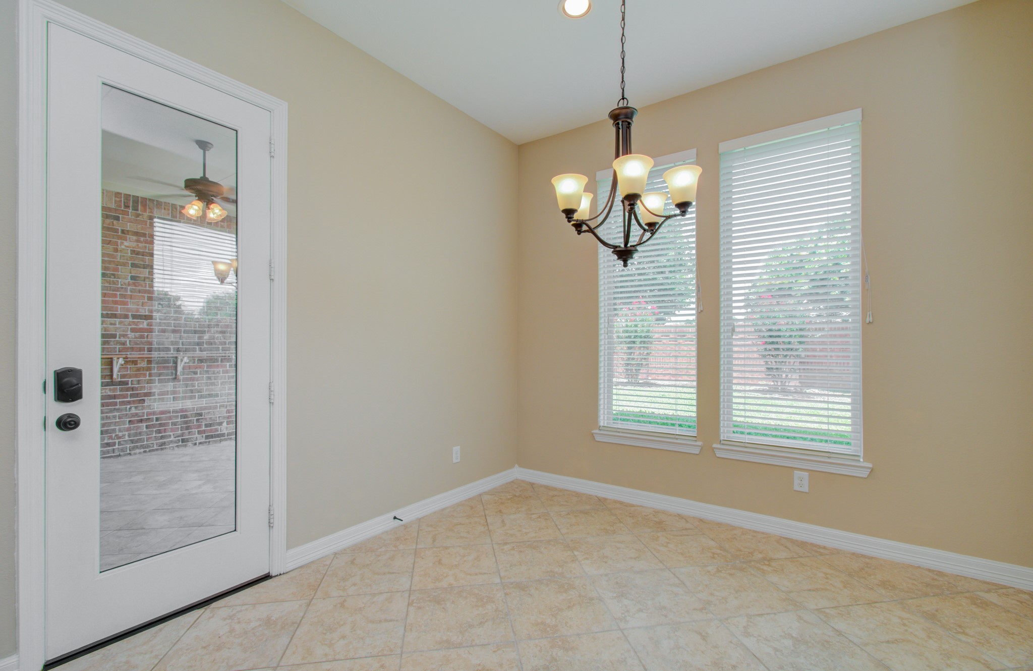 3938 May Ridge Lane Sugar Land, TX 77479 - Photo 16 of 40 a view of a livingroom with a chandelier fan and windows