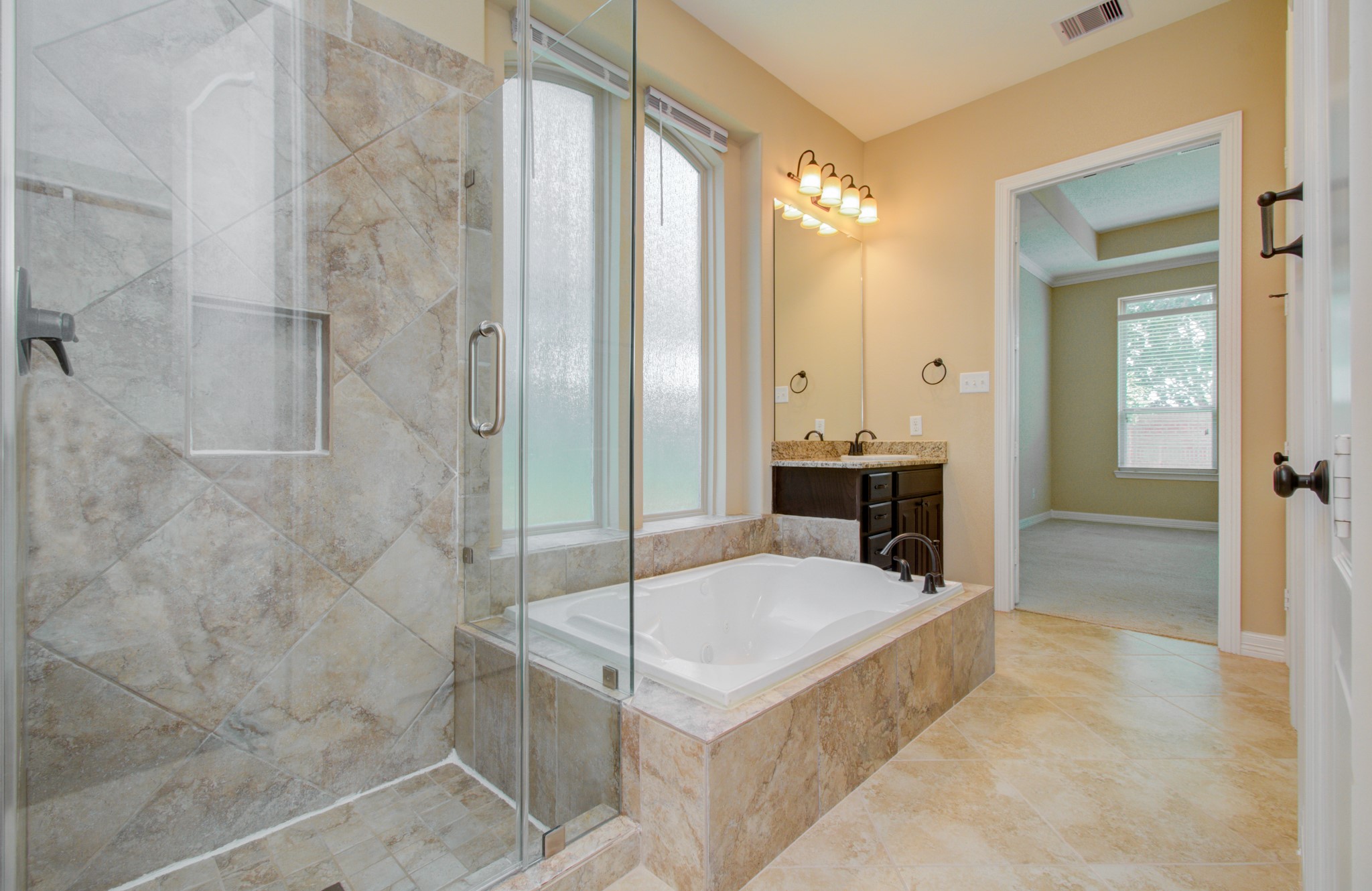 3938 May Ridge Lane Sugar Land, TX 77479 - Photo 22 of 40 a bathroom with a tub shower and sink