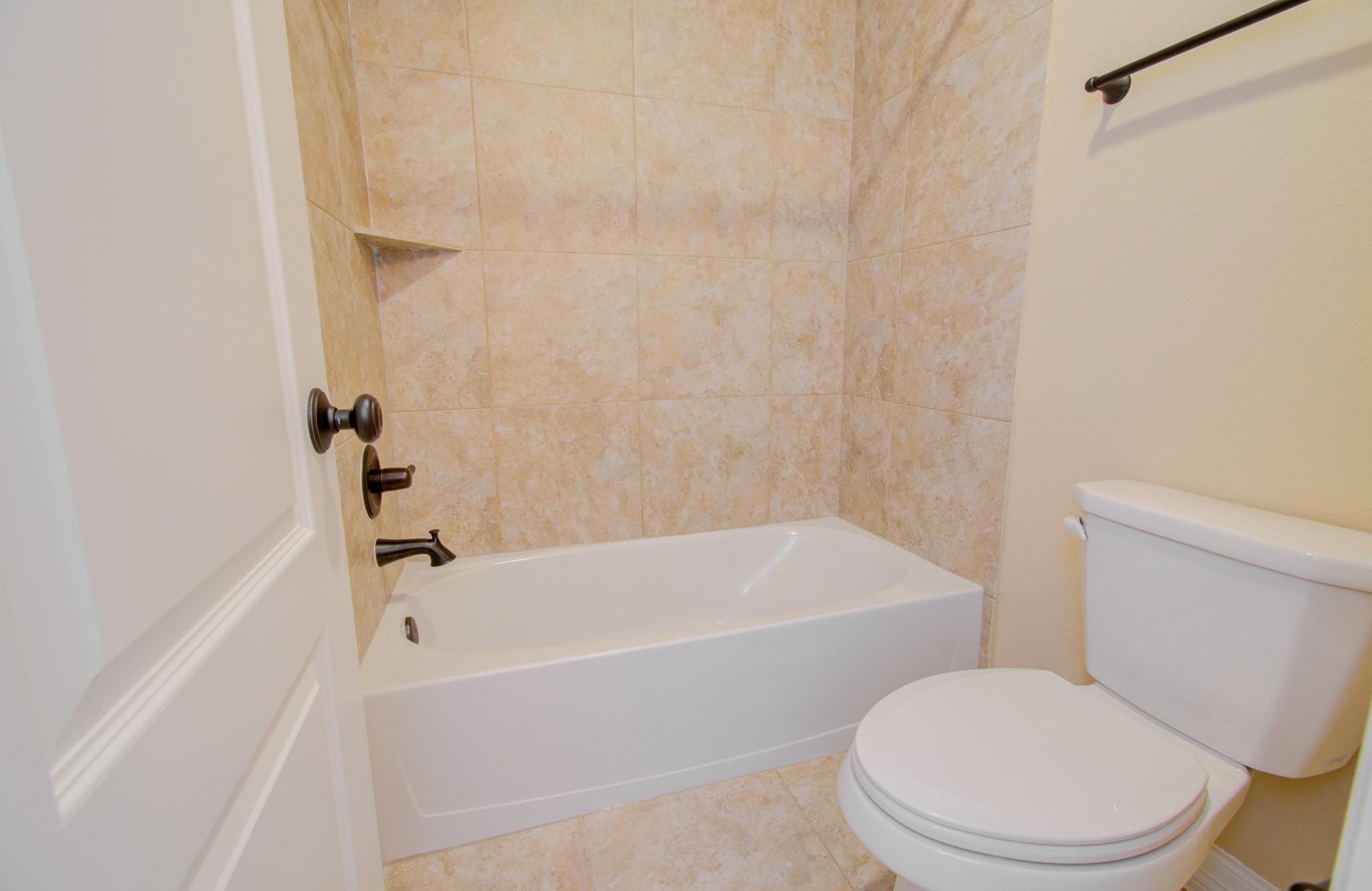 3938 May Ridge Lane Sugar Land, TX 77479 - Photo 30 of 40 a white toilet and tub sitting next to a bathroom sink