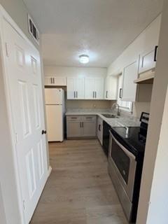 1846 Sturgeon Road Buford, GA 30518 - Photo 6 of 14 a kitchen with a sink a stove top oven and refrigerator