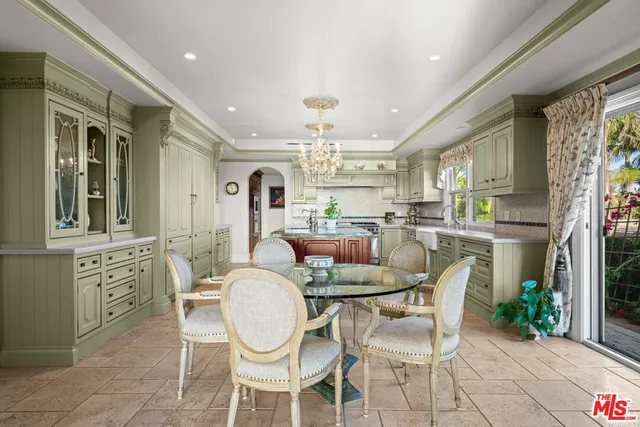 a spacious bedroom with a large bed and a chandelier