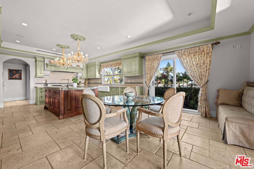 1575 Alexis Place Beverly Hills, CA 90210 - Photo 18 of 75 a dining room with furniture a chandelier and kitchen view