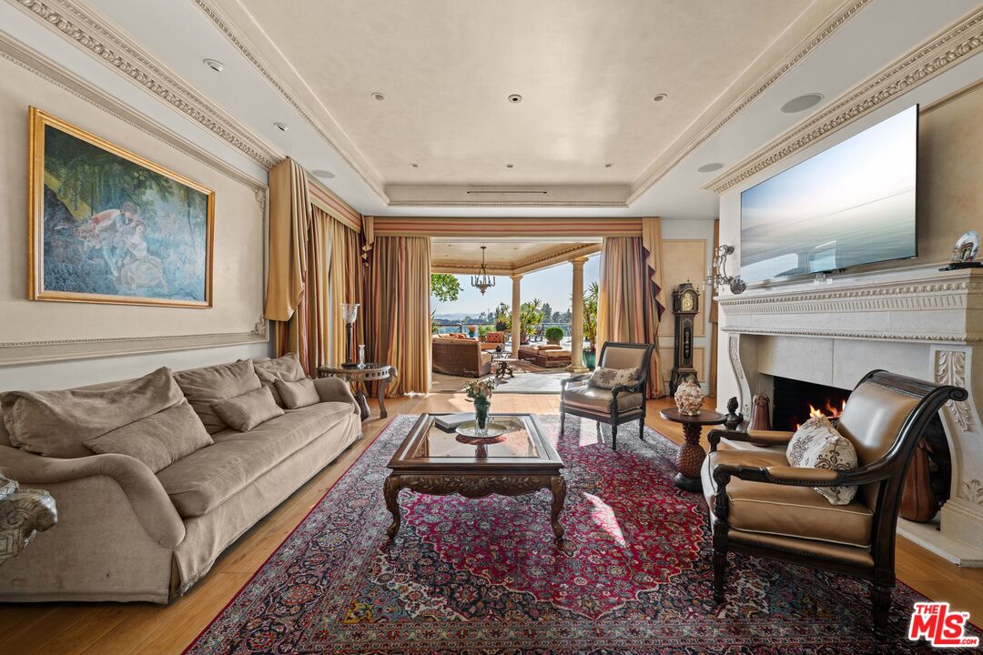 1575 Alexis Place Beverly Hills, CA 90210 - Photo 21 of 75 a living room with furniture fireplace and flat screen tv
