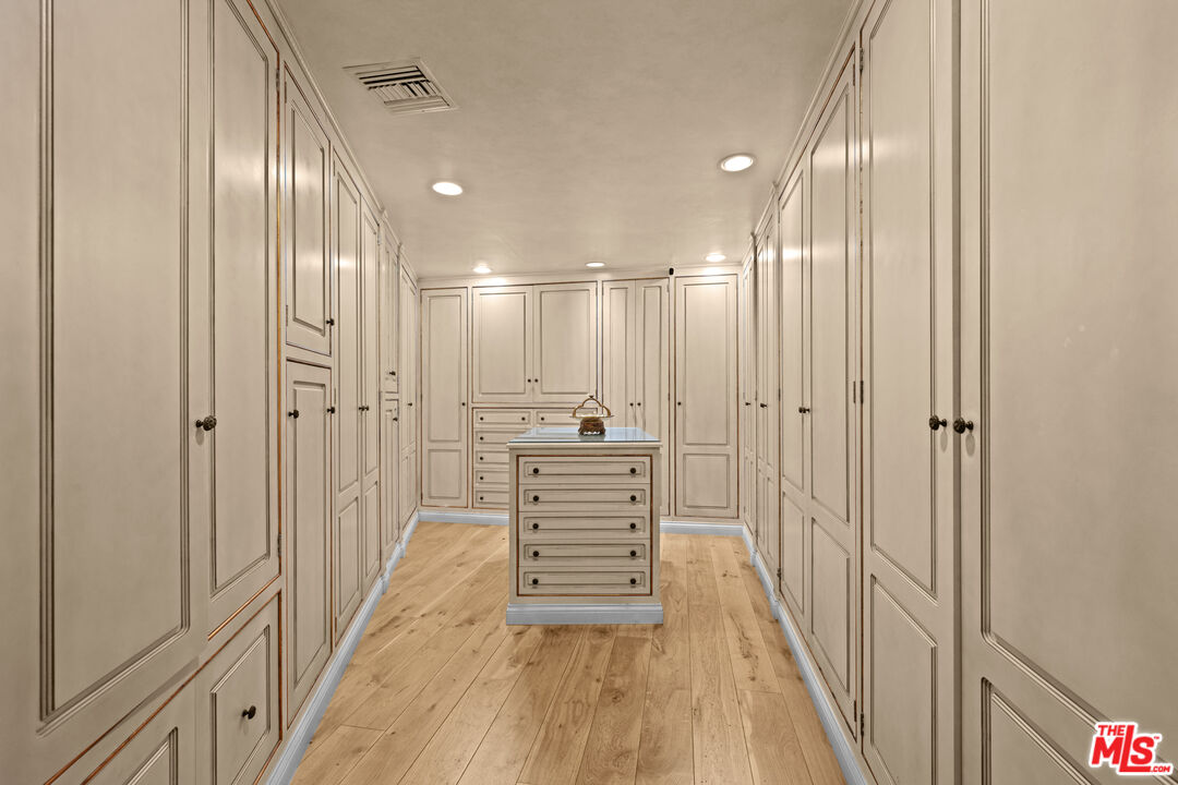 1575 Alexis Place Beverly Hills, CA 90210 - Photo 29 of 75 a view of a hallway with wooden floor and a bathroom