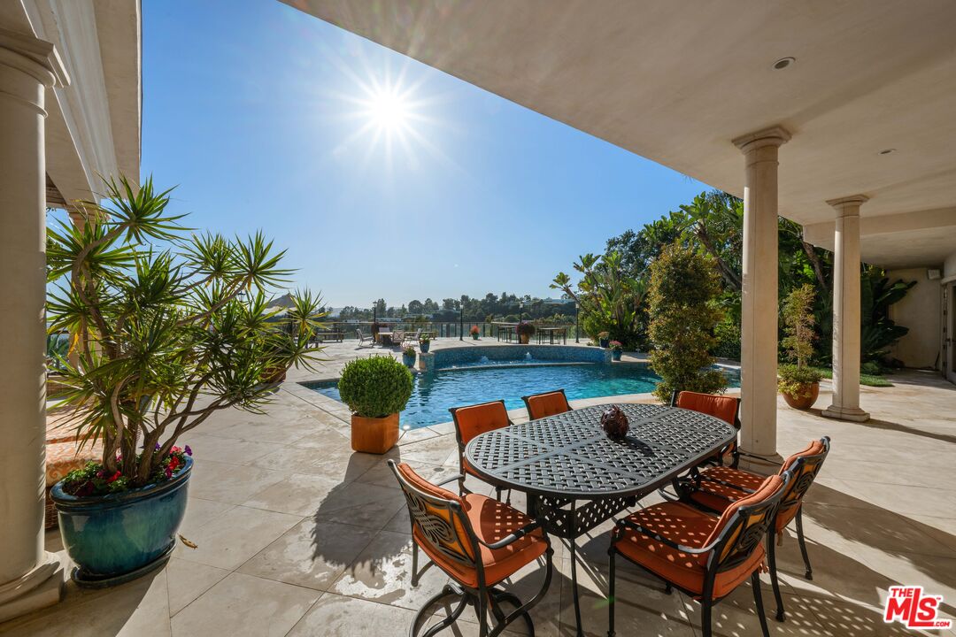 1575 Alexis Place Beverly Hills, CA 90210 - Photo 37 of 75 a backyard of a house with table and chairs