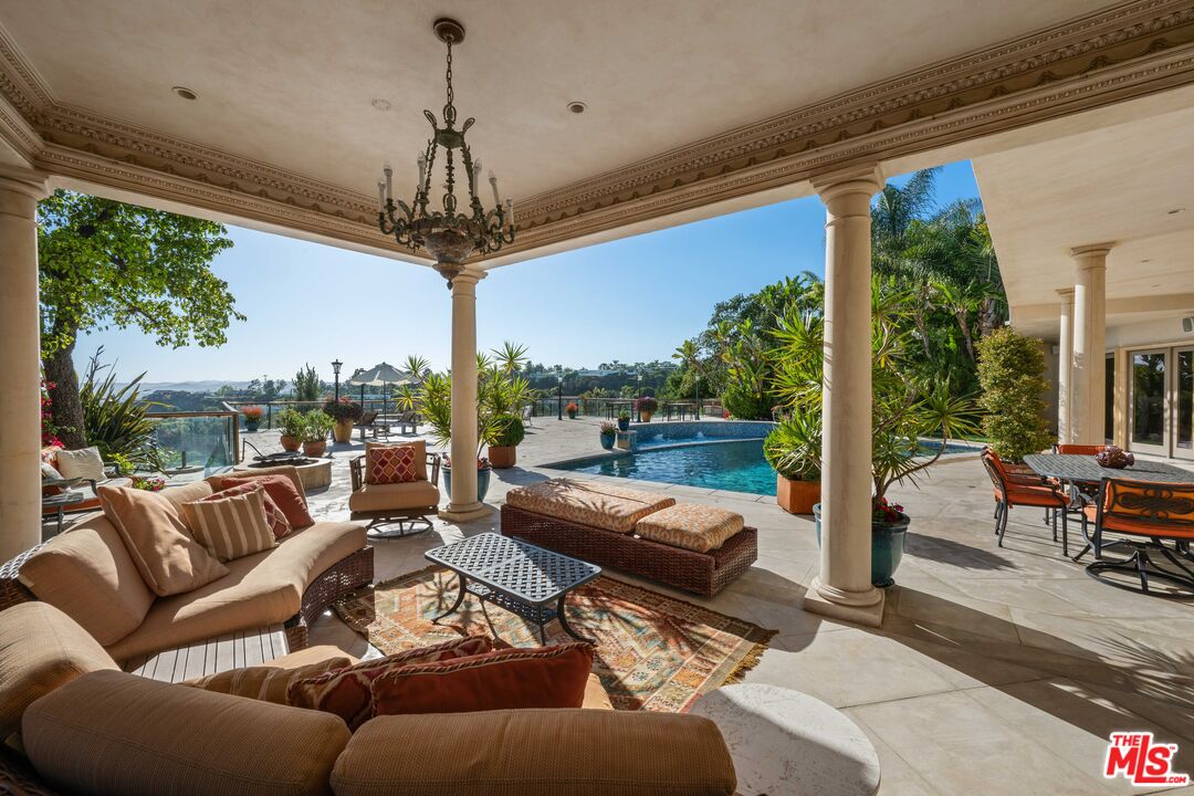 1575 Alexis Place Beverly Hills, CA 90210 - Photo 38 of 75 a living room with patio furniture and a floor to ceiling window