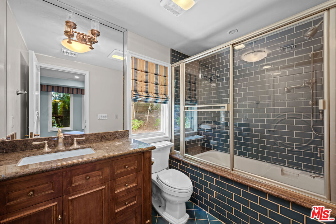 1575 Alexis Place Beverly Hills, CA 90210 - Photo 57 of 75 a bathroom with a granite countertop sink toilet and shower