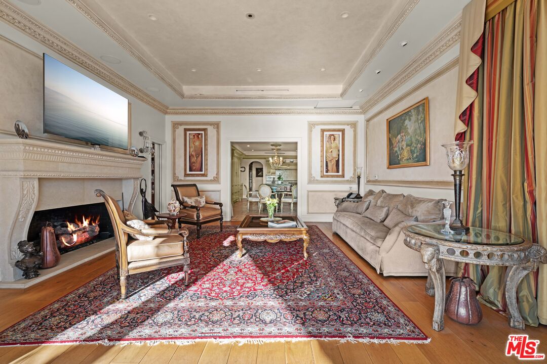 1575 Alexis Place Beverly Hills, CA 90210 - Photo 61 of 75 a living room with furniture and a fireplace