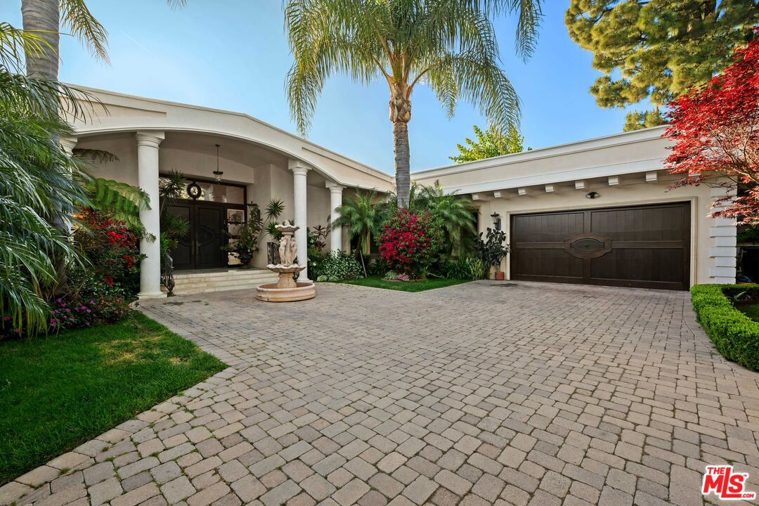 1575 Alexis Place Beverly Hills, CA 90210 - Photo 67 of 75 a view of a house with a yard and palm trees