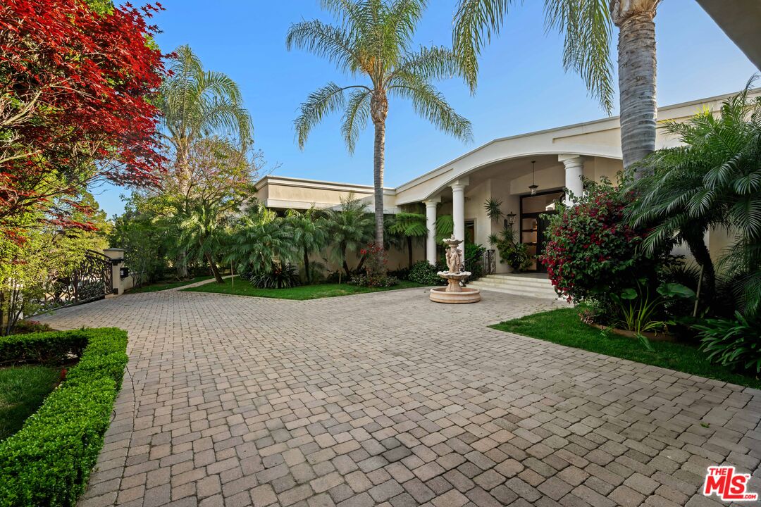 1575 Alexis Place Beverly Hills, CA 90210 - Photo 69 of 75 a view of a patio with a table and chairs under an umbrella