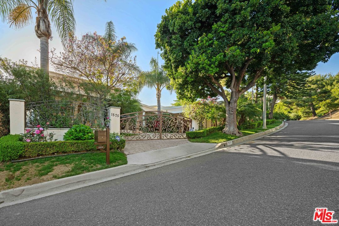 1575 Alexis Place Beverly Hills, CA 90210 - Photo 71 of 75 a view of a house with a yard and potted plants