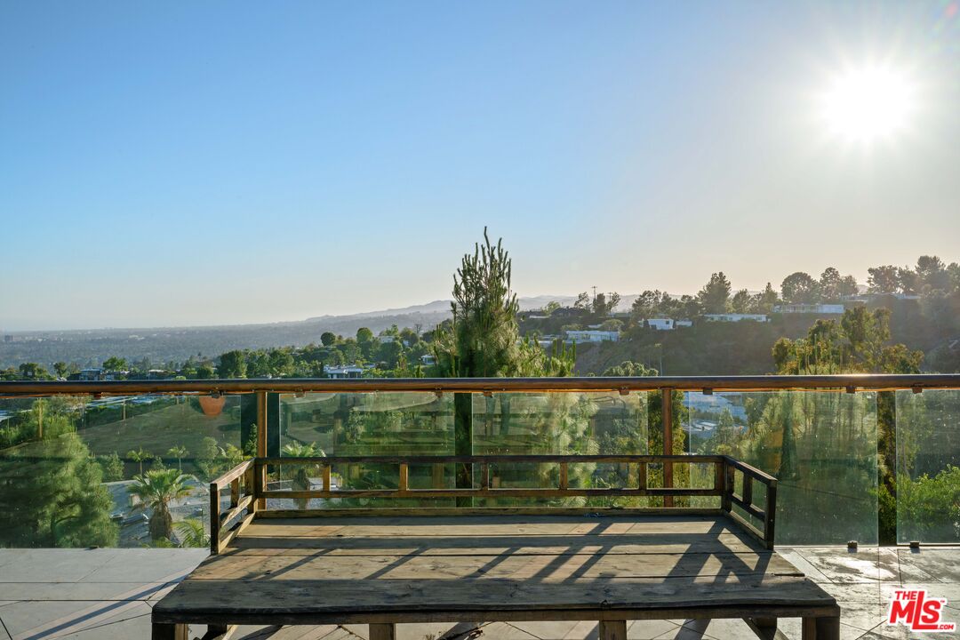 1575 Alexis Place Beverly Hills, CA 90210 - Photo 75 of 75 a view of a lake with a bench in front of lake