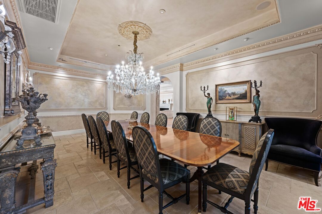 1575 Alexis Place Beverly Hills, CA 90210 - Photo 10 of 75 a view of a dining room with furniture and chandelier
