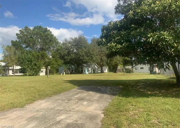 a view of grassy field with trees