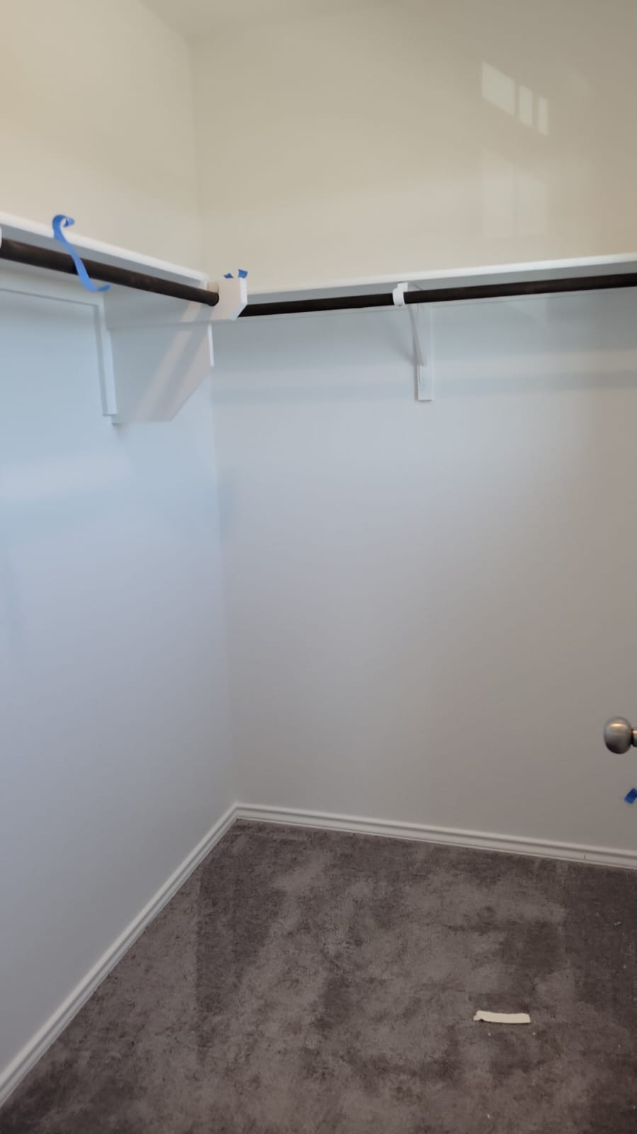 541 Pickrell Loop Georgetown, TX 78628 - Photo 18 of 32 The property features a closet with white shelving and dark-toned hanging rods