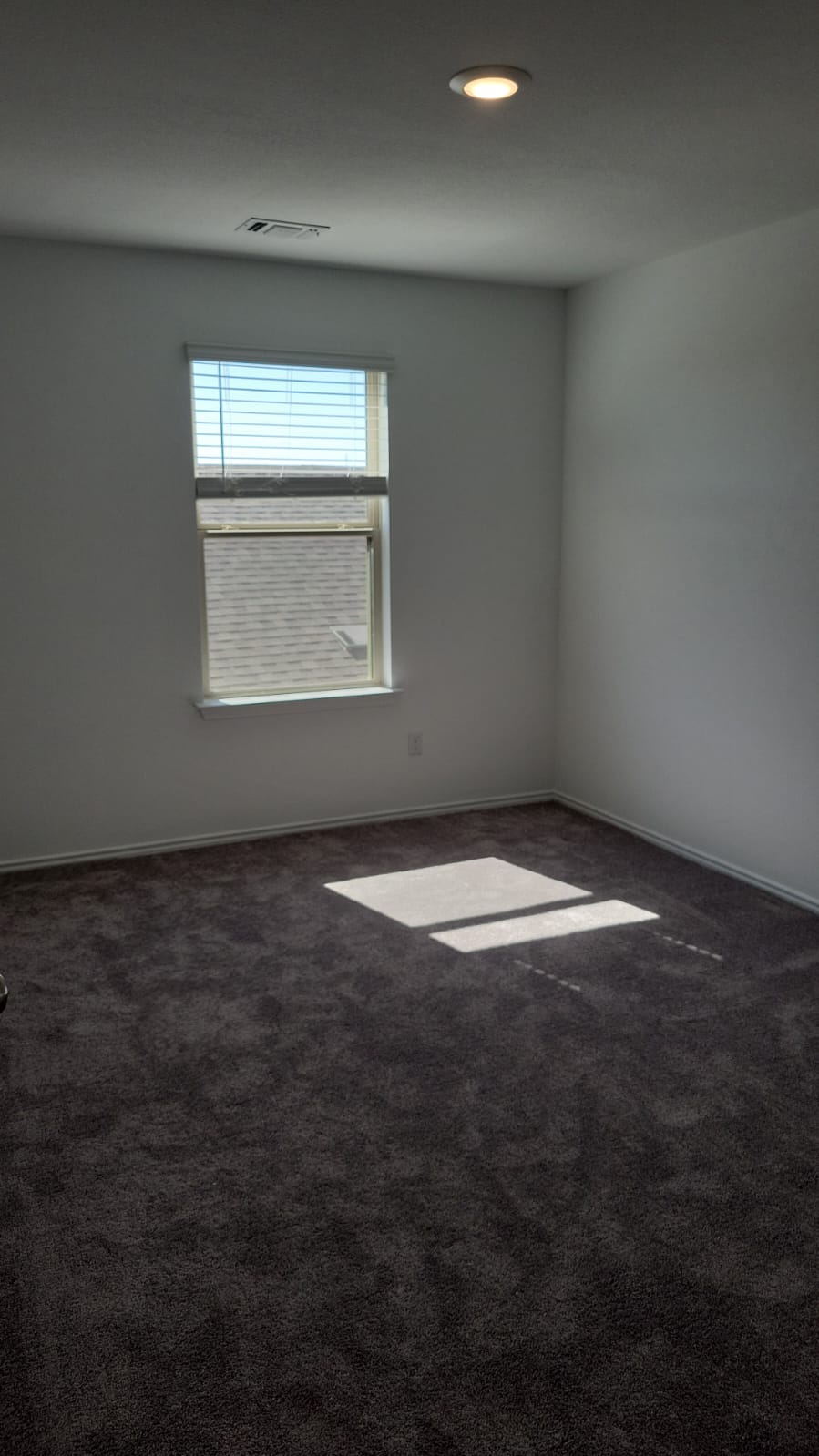 541 Pickrell Loop Georgetown, TX 78628 - Photo 21 of 32 This room features a window with blinds, carpeted flooring, and a recessed ceiling light fixture