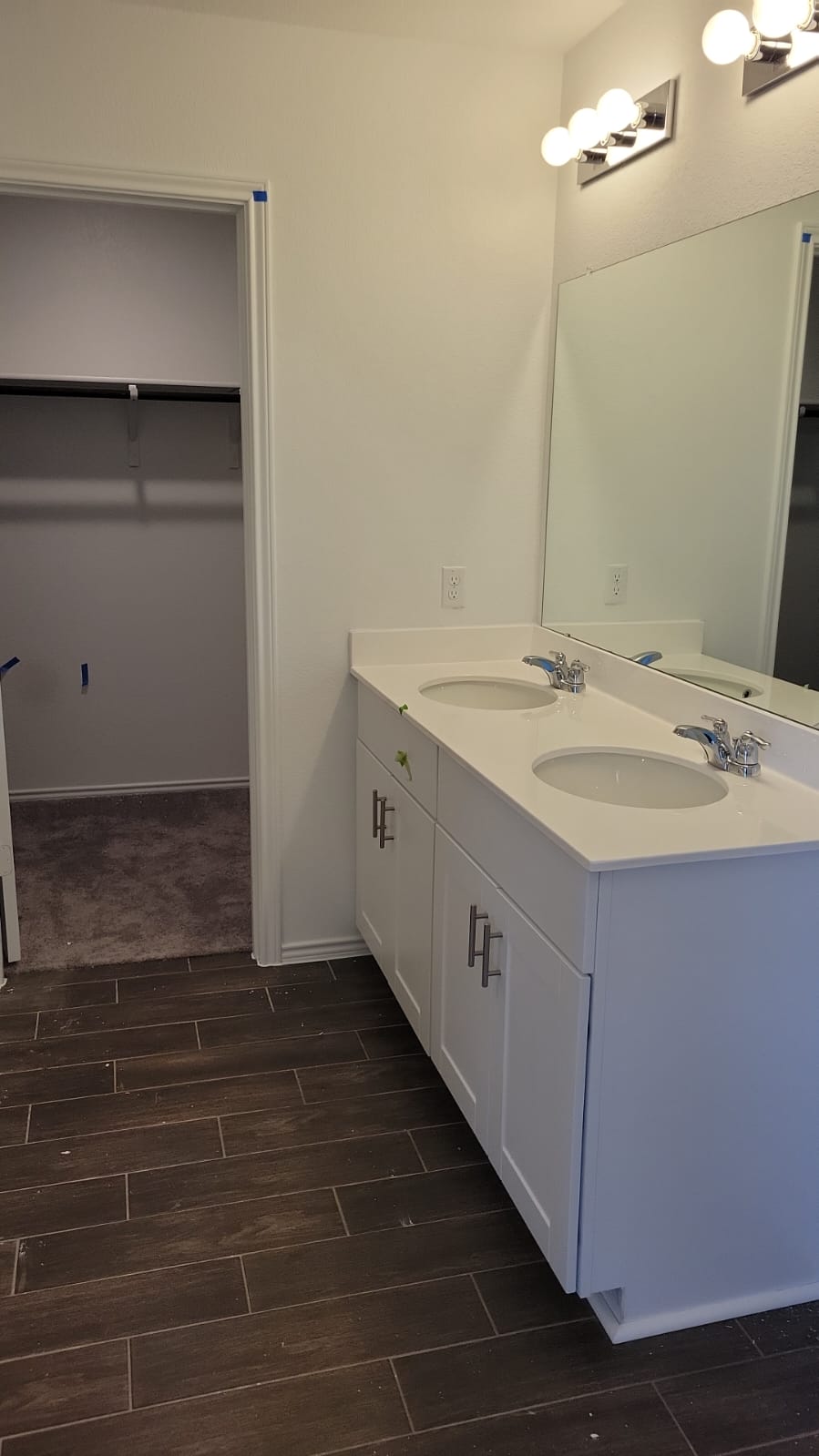 541 Pickrell Loop Georgetown, TX 78628 - Photo 24 of 32 Bathroom featuring a white double vanity with undermount sinks, contemporary faucets, and a large mirror