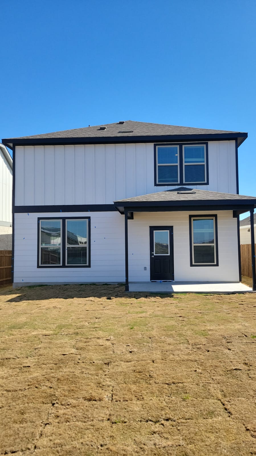 541 Pickrell Loop Georgetown, TX 78628 - Photo 29 of 32 The property features a two-story exterior with white siding and dark trim, providing a contemporary aesthetic