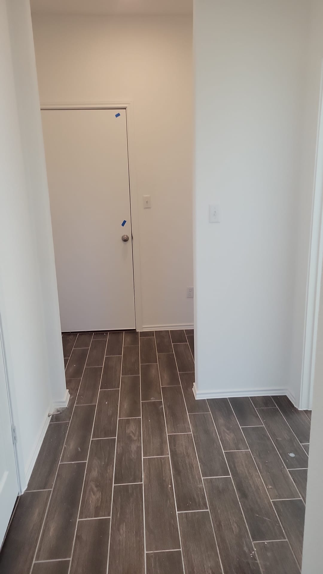 541 Pickrell Loop Georgetown, TX 78628 - Photo 6 of 32 Hallway featuring wood-look tile flooring and white walls