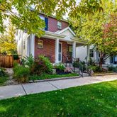 a front view of a house with a yard and trees