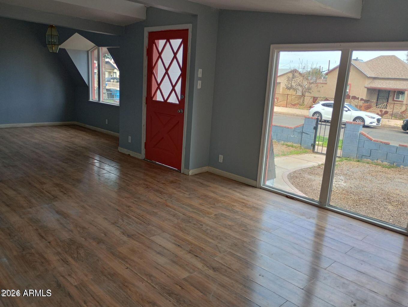 1333 West Taylor Street Phoenix, AZ 85007 - Photo 2 of 6 an empty room with wooden floor and windows
