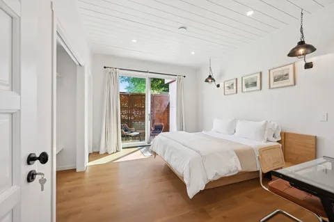 a bedroom with a large bed and a window