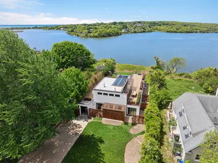an aerial view of a house with a lake view