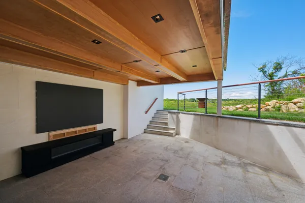 a backyard of a house with table and chairs
