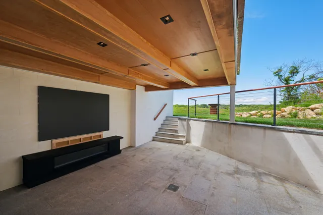 a backyard of a house with table and chairs