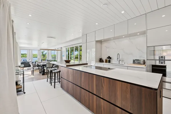 a kitchen with counter space dining table and chairs