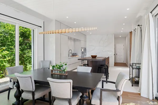 a dining room with furniture window and wooden floor