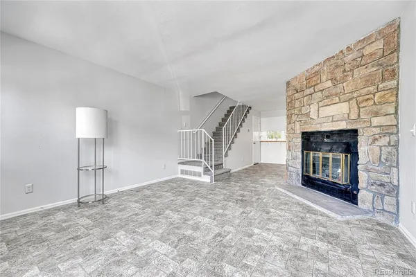 a view of empty room with a fireplace