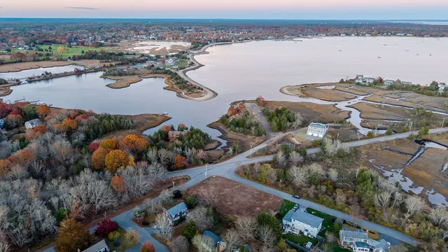 an aerial view of lake and residential houses with outdoor space