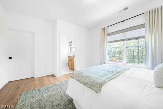 a spacious bedroom with a bed and a window