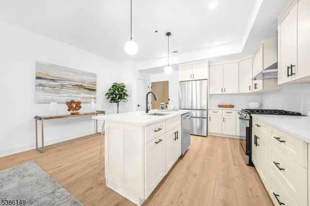 a kitchen with white cabinets and white appliances