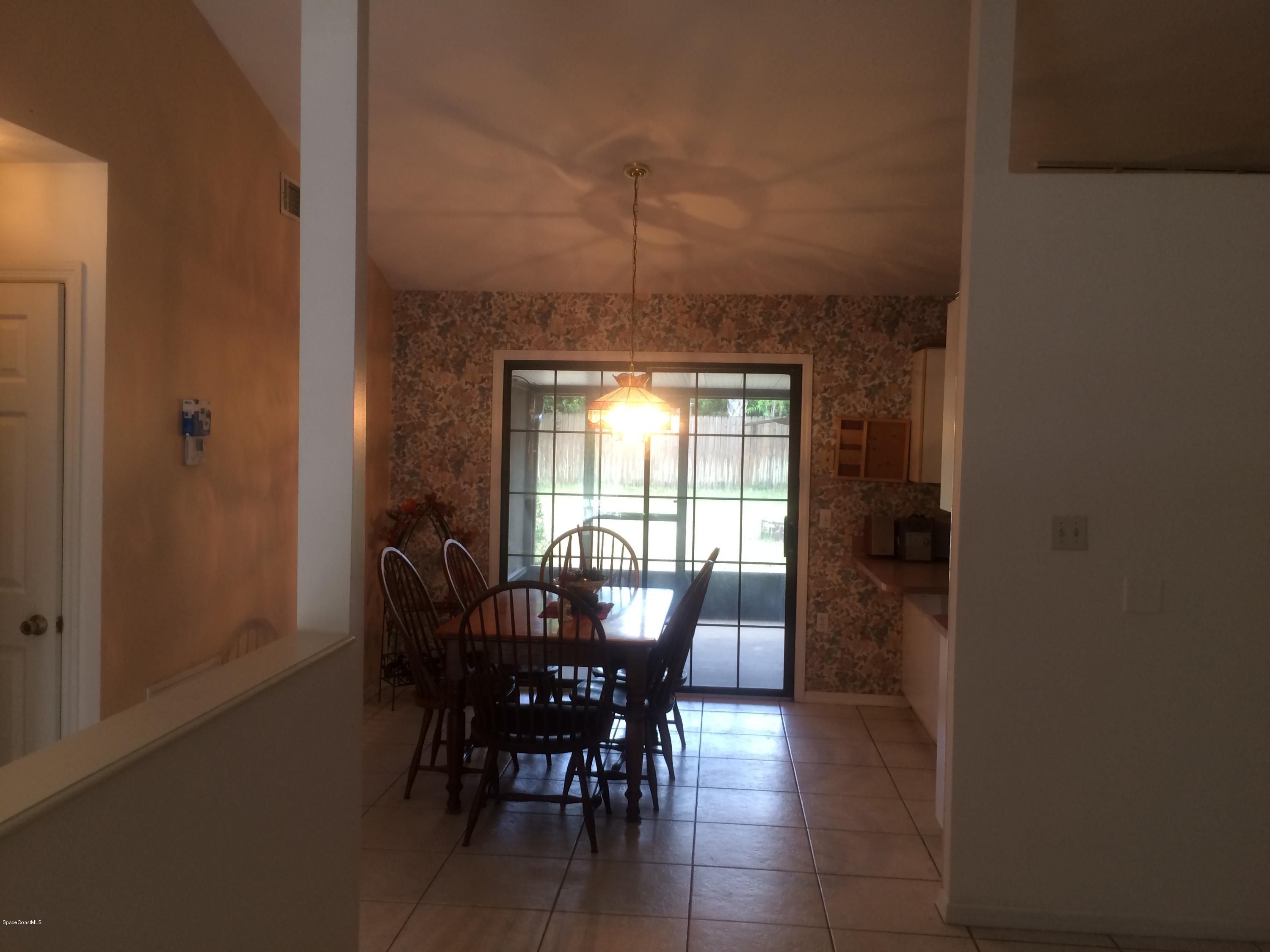 4671 Alfred Street Cocoa, FL 32927 - Photo 2 of 19 a view of a dining room with furniture and window