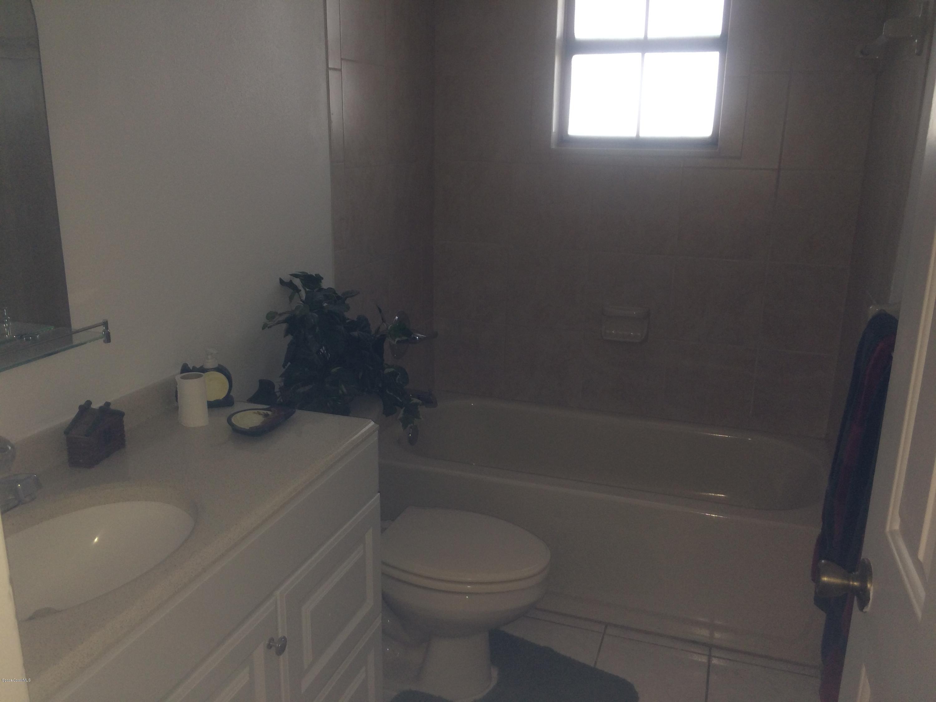 4671 Alfred Street Cocoa, FL 32927 - Photo 13 of 19 a bathroom with a sink a toilet and shower