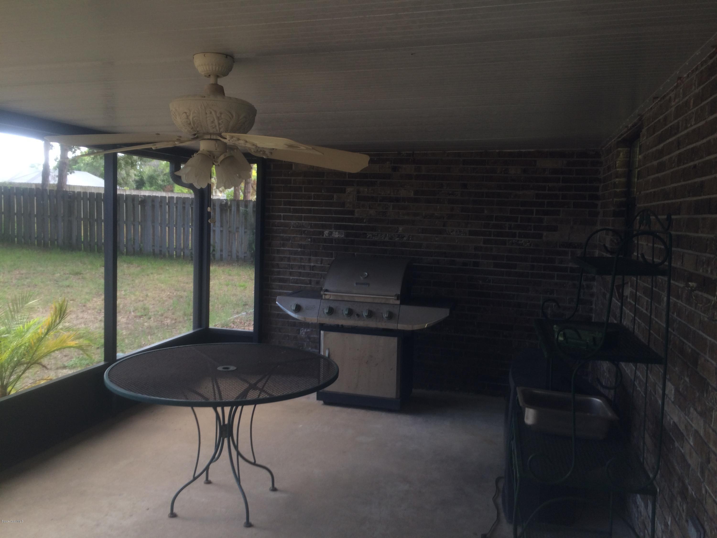 4671 Alfred Street Cocoa, FL 32927 - Photo 16 of 19 a kitchen with a sink and a table in it