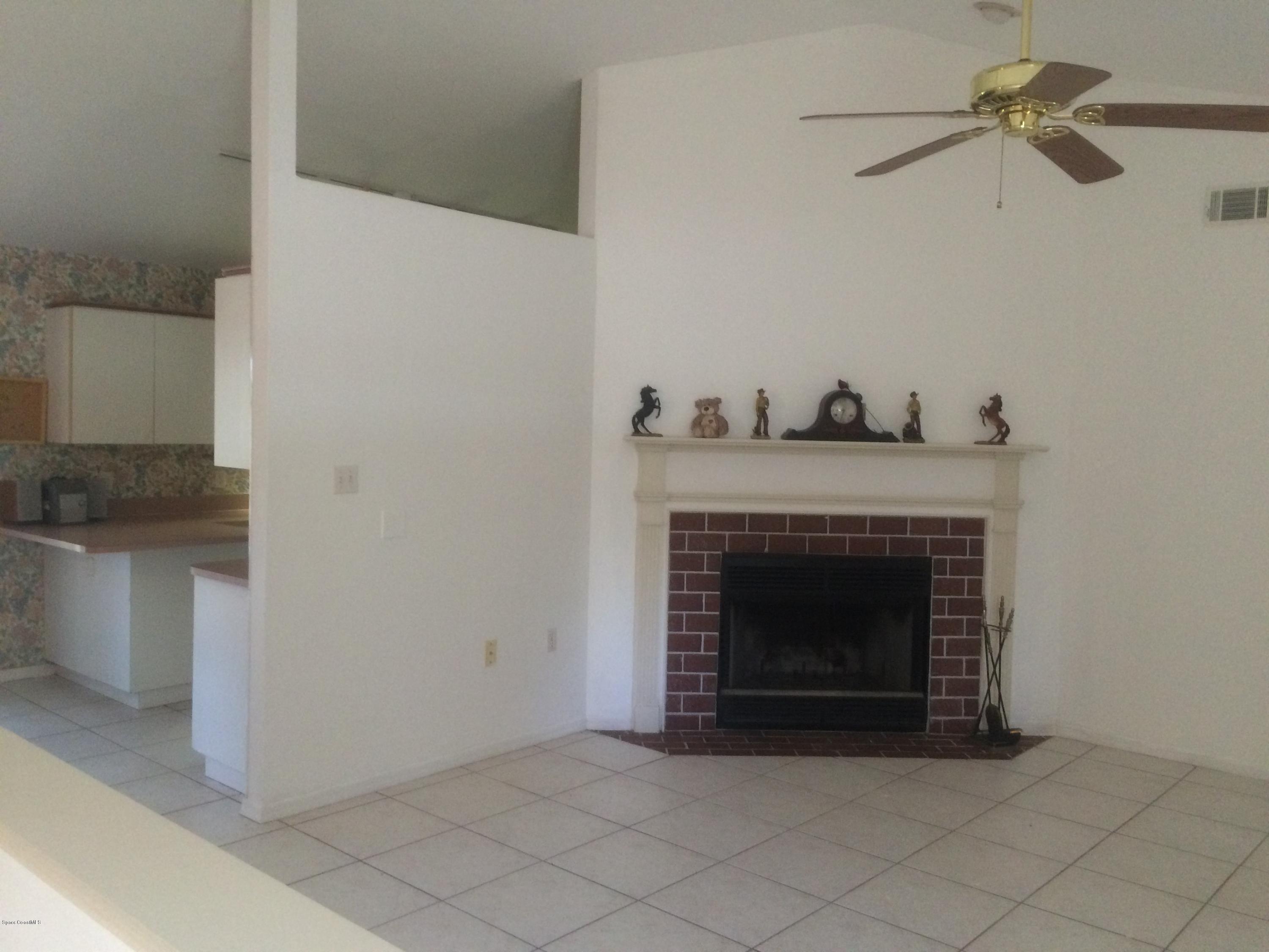 4671 Alfred Street Cocoa, FL 32927 - Photo 3 of 19 a living room with furniture and a fireplace