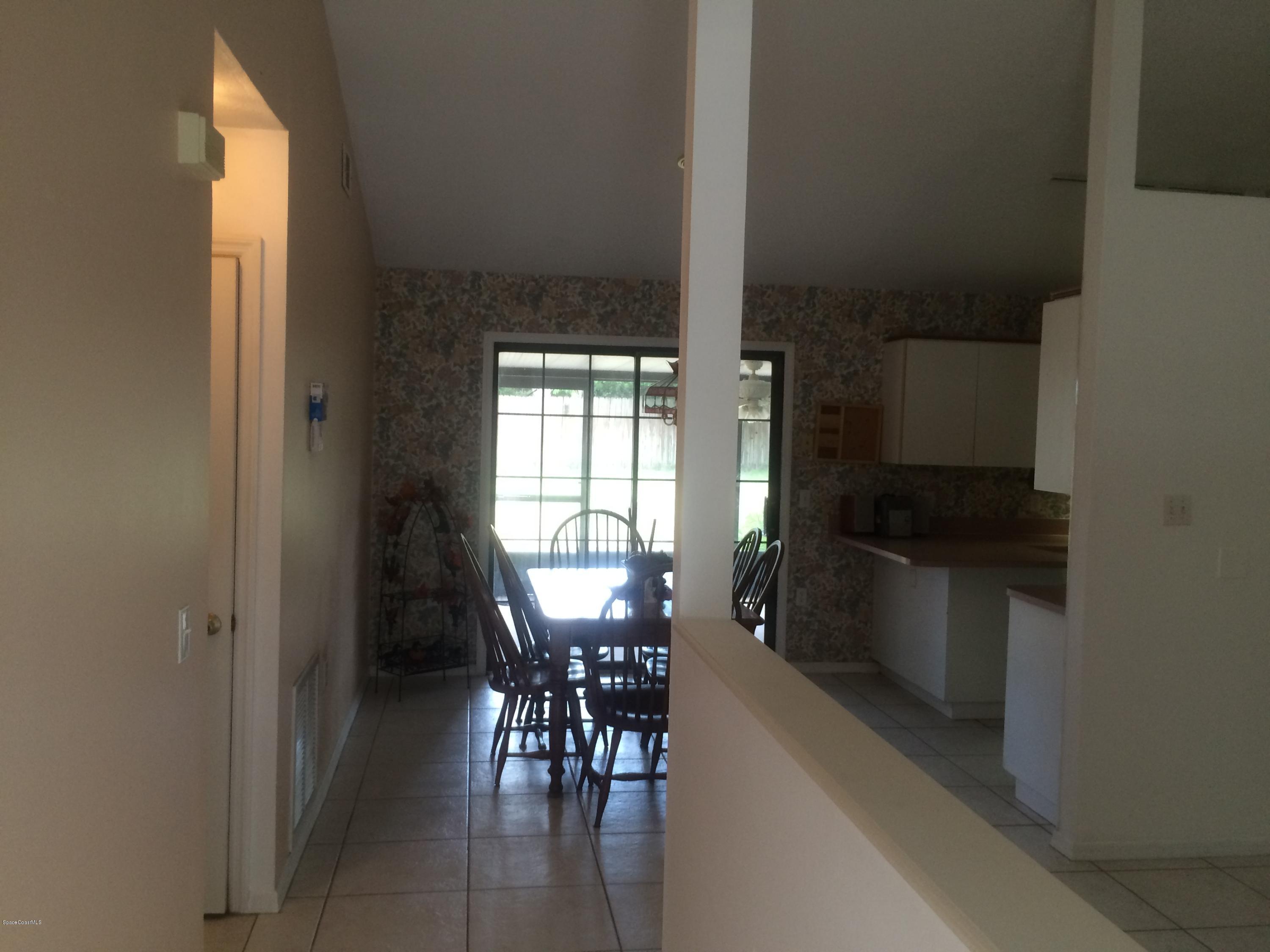 4671 Alfred Street Cocoa, FL 32927 - Photo 4 of 19 a kitchen with a table and chairs in it
