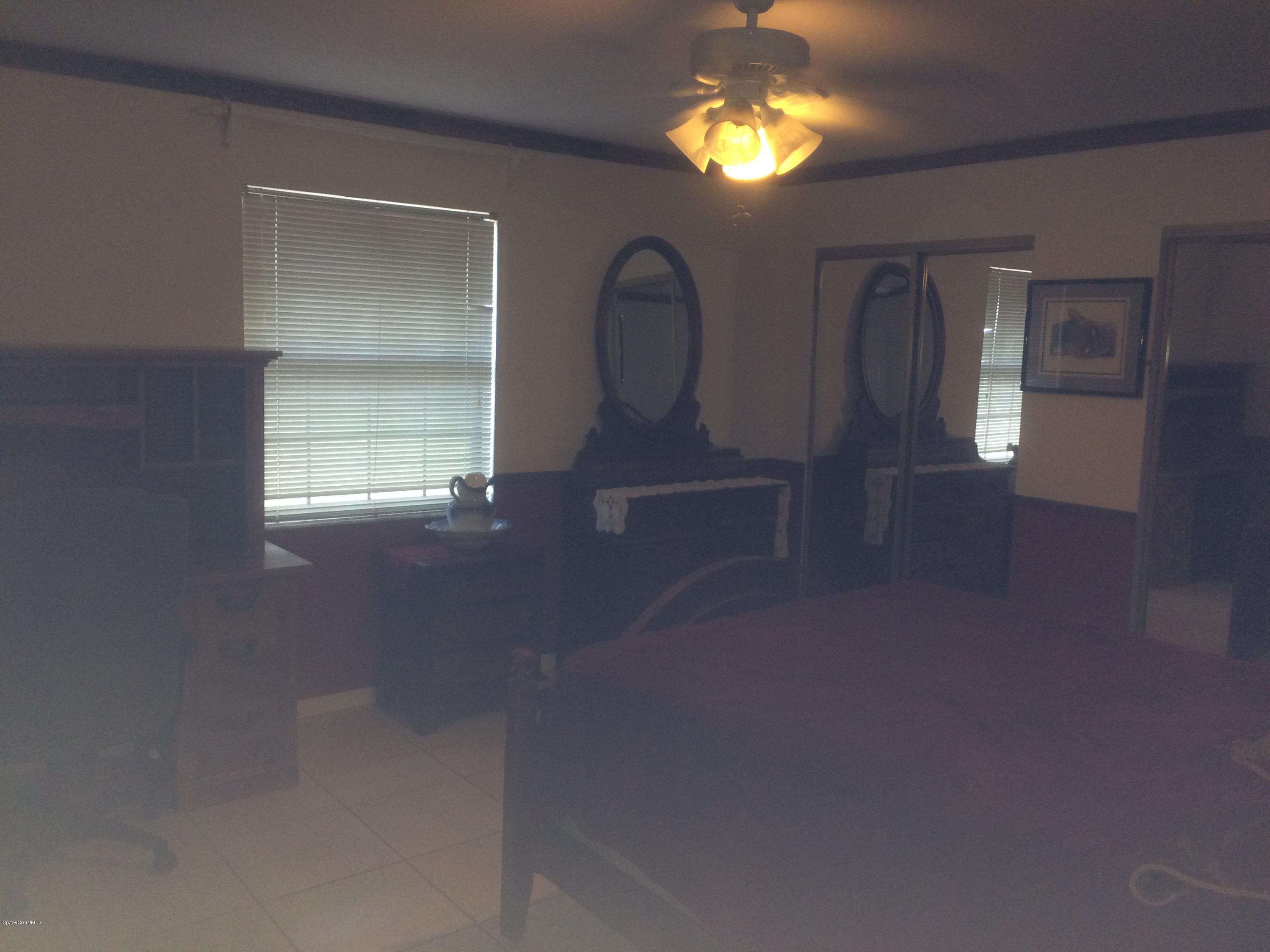 4671 Alfred Street Cocoa, FL 32927 - Photo 7 of 19 wooden floor in an empty room with a window